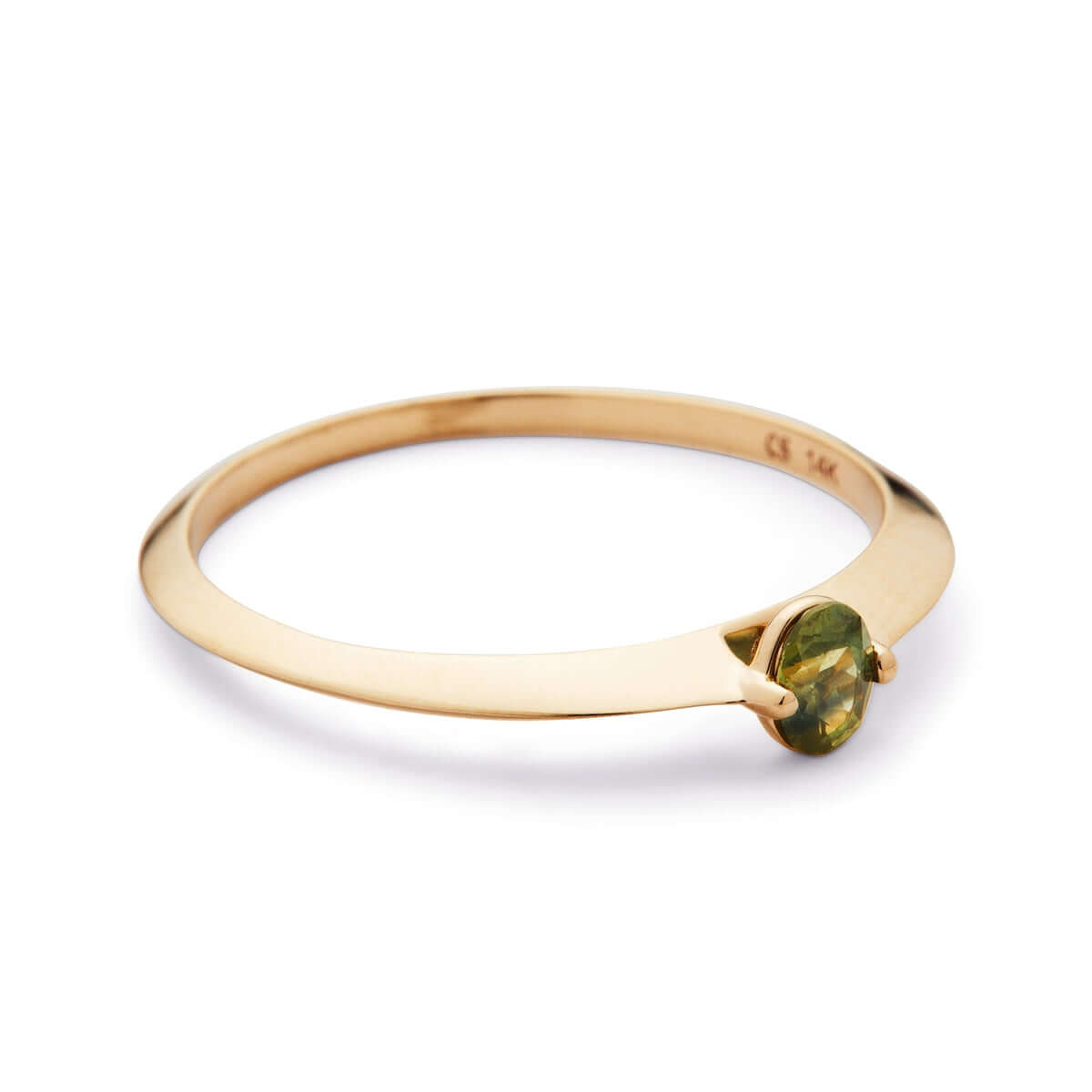 Close-up view of a minimalist ring, with a prong setting that cradles the oval Australian sapphire on a thin gold band, set against a white backdrop.