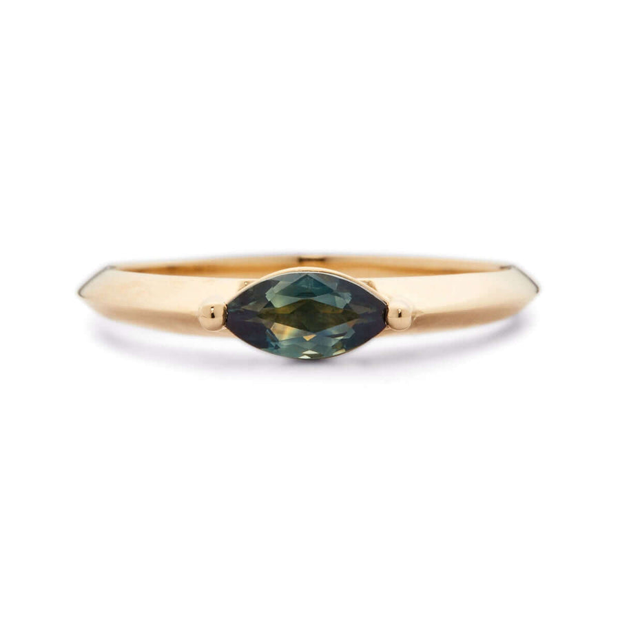 A yellow gold ring with a marquise-cut Australian sapphire on a white background