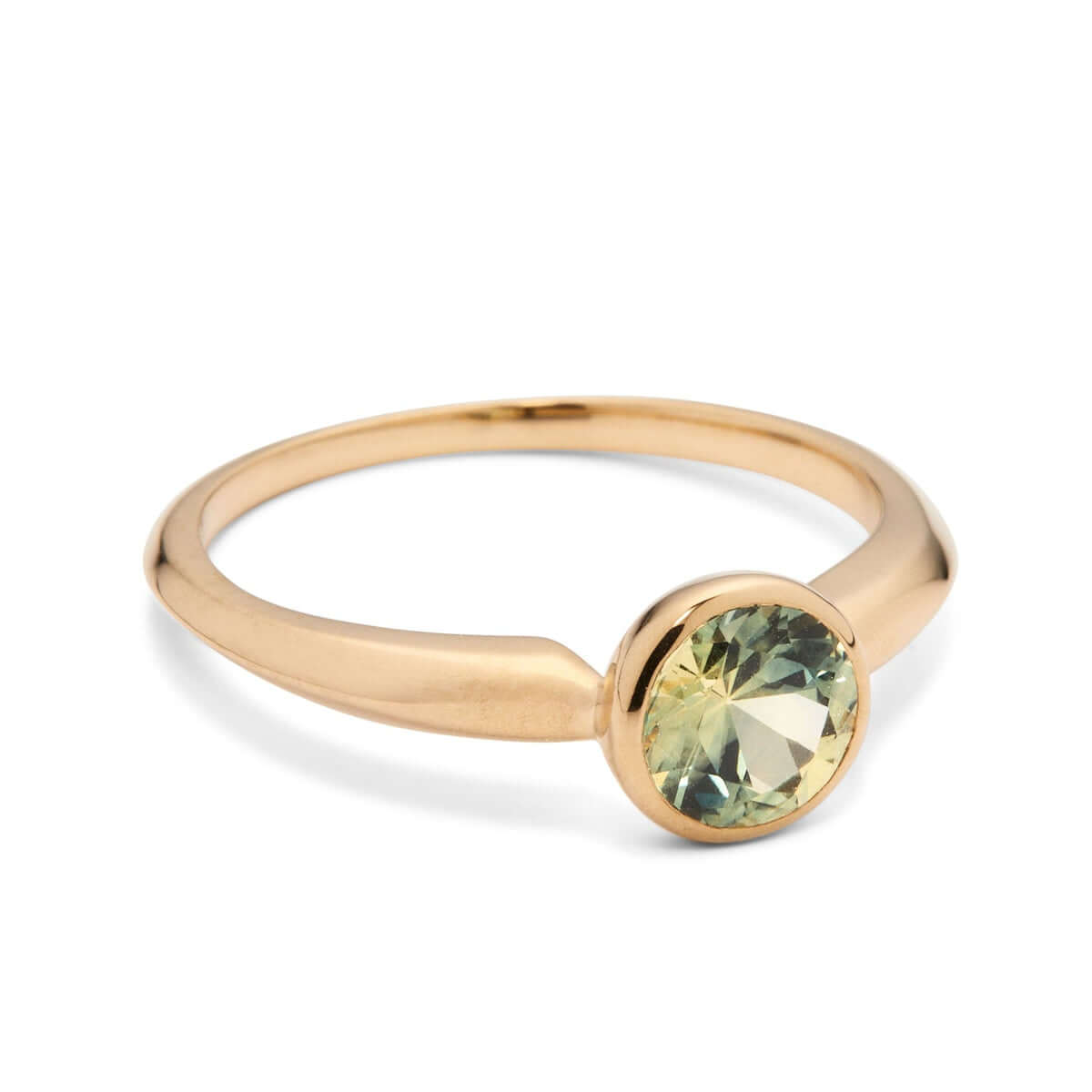 An angled side view of the 'Lou' ring, showing the elegant contrast between the bicolor sapphire and the knife-edge gold band, on a white surface.