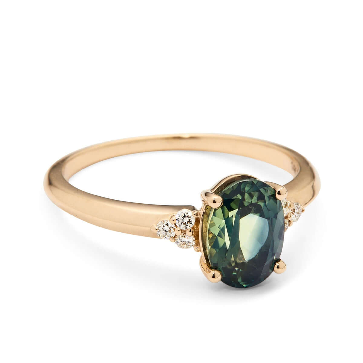 An elegant yellow gold ring featuring a teal Australian sapphire framed by a three triangle diamond on each side.