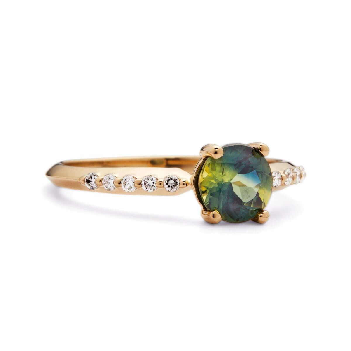A close-up of a yellow gold ring with a bi-color Australian sapphire, ten diamonds in a line, and a knife-edge band design.