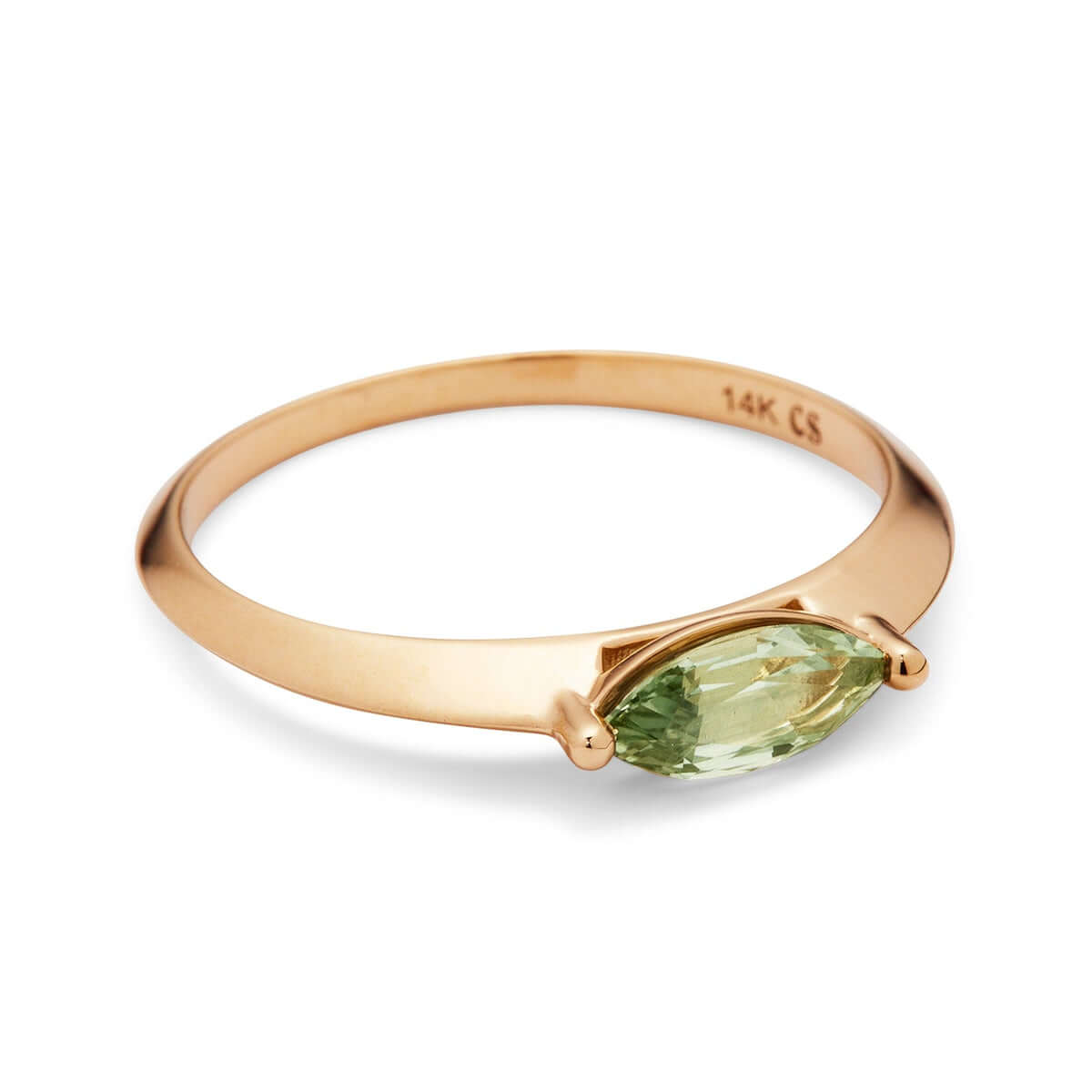 A yellow gold ring with a marquise Montana sapphire, shown at an angle.