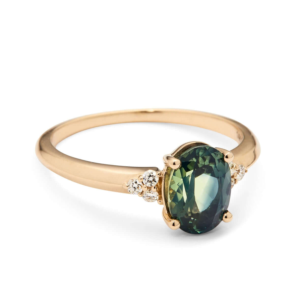 An elegant yellow gold ring featuring a teal Australian sapphire framed by a three triangle diamond on each side. 