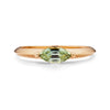 A yellow gold ring featuring a marquise Montana sapphire on a white background.